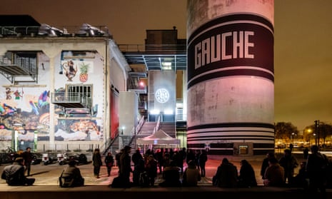 At night, gig-goers hang outside La Sucrière, a huge arts and music space, formerly a sugar warehouse, in Lyon, France.