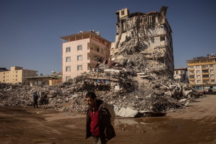 A man walks past a destroyed building in Nurdağı, about 30 miles west of Gaziantep.