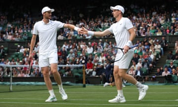 Jamie and Andy Murray high-five each other on Centre Court