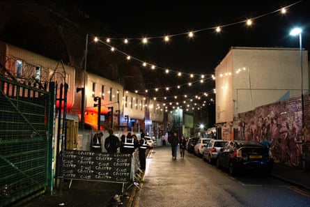 Digbeth, an ex-industrial neighbourhood in Birmingham, at night with people walking past a club