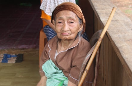 Elderly woman sits in a chair