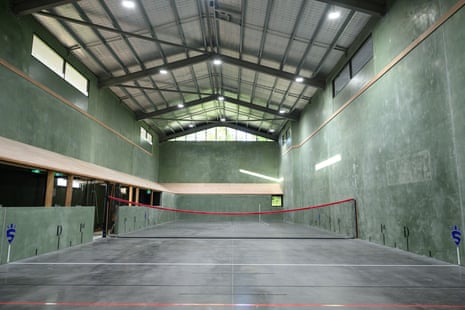 Tennis net inside green building with high roof