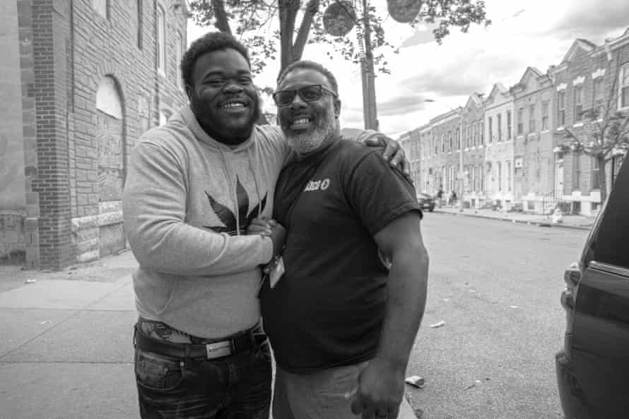 Teshombae Harvell embraces one of the Roca clients he has spent months working with in East Baltimore.