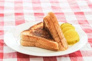 A toasted cheese sandwich with pickles