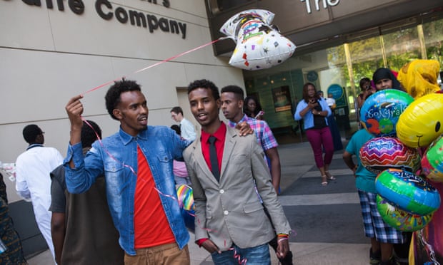 Two friends walk out of the Minneapolis Children’s Theatre Company after a high school graduation ceremony. Young Somali men are especially affected by stereotypes of Islamic radicalization.