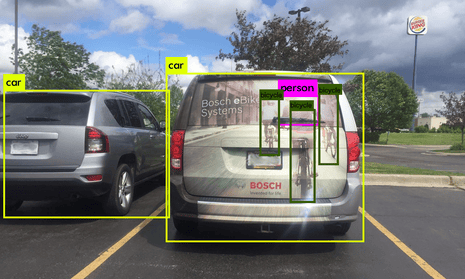 What a self-driving car’s camera sees when it looks at a car with an advert on the back.