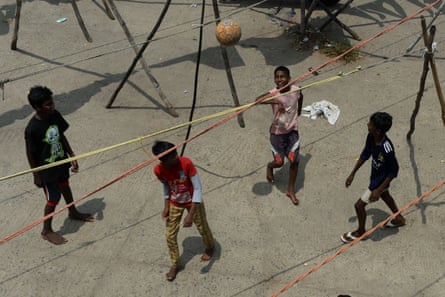 Kids play football at a deserted open-air laundry during a government-imposed nationwide lockdown as a preventive measure against coronavirus in Chennai on 8 April 2020.