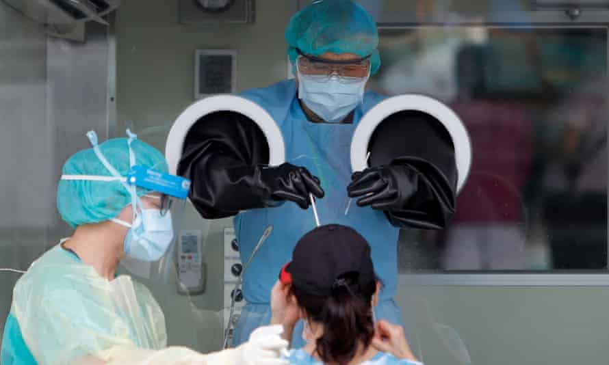 A lady gets a rapid Covid-19 test at a testing center in New Taipei, following a surge of domestic cases and deaths.