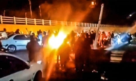 A screengrab from a video reportedly shows Iranian protesters gathered on a road leading to Evin prison on Saturday night