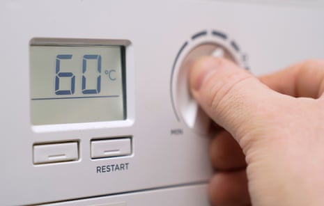 A homeowner turns down the temperature of a gas boiler in Basingstoke, Hampshire.