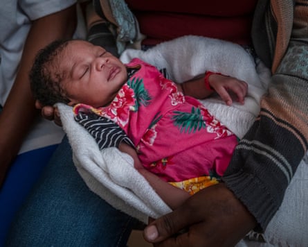 A baby on a woman’s lap