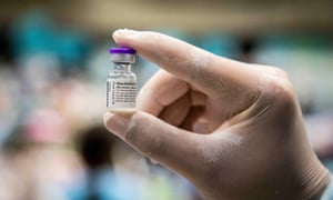 A nurse holds up a vial of the Pfizer vaccine.