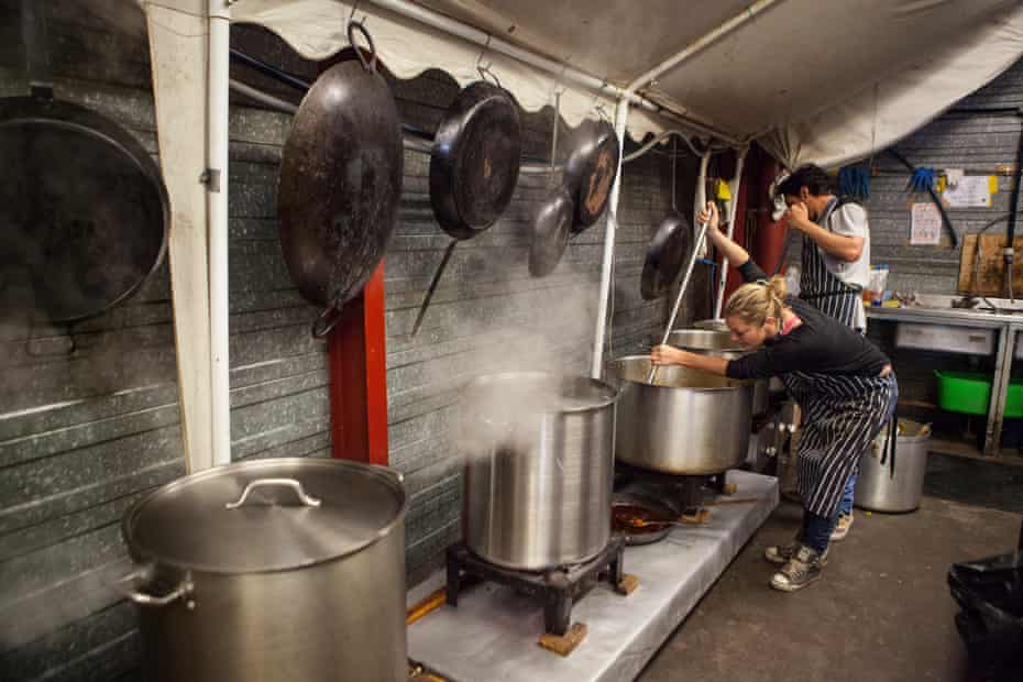 Help Refugees volunteers cooking and preparing food for the refugees at the Calais refugee camp