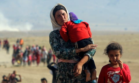 Displaced people from the minority Yazidi sect, fleeing violence from forces loyal to the Islamic State in Sinjar, Iraq