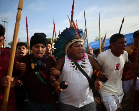 Men walk in a line while linking arms