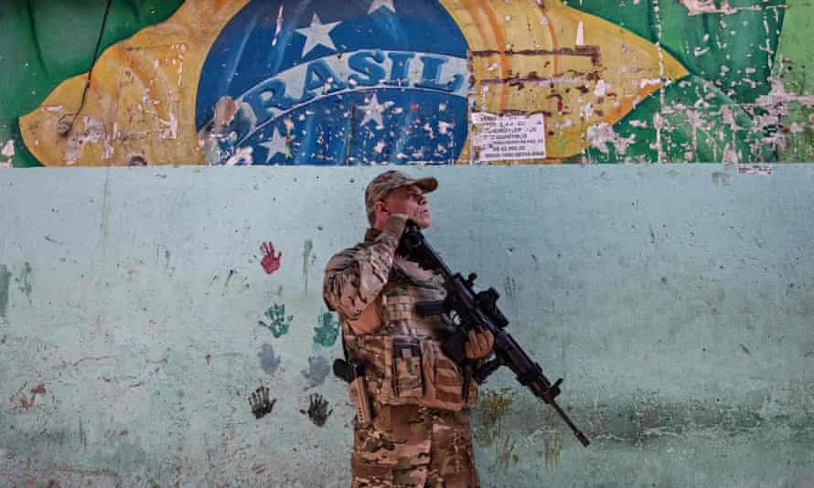 A special operations member of the Brazilian civil police stands guard during the occupation of Jacarezinho favela in Rio de Janeiro