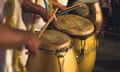 Group of men playing yellow drums at carnival parade at night<br>Brazil batucada musicians. Party event celebration concept. Loud music performers