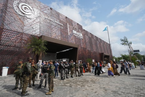Security personnel patrol outside the venue for Cop30 as attendees arrive for the climate summit.