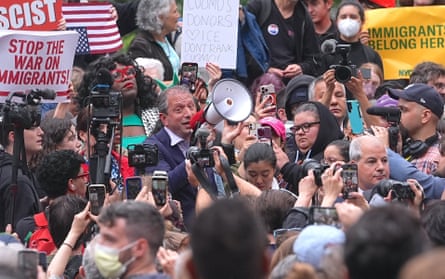 Man talks to crowd via loudspeaker