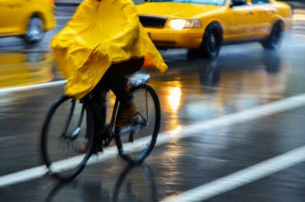 Cyclist in yellow poncho during rain in New York City
