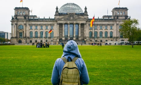 Young woman with backpack looking at Bundestag building in Berlin