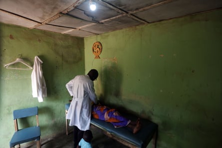 A doctor examines a pregnant woman at a solar-powered clinic in Nigeria.