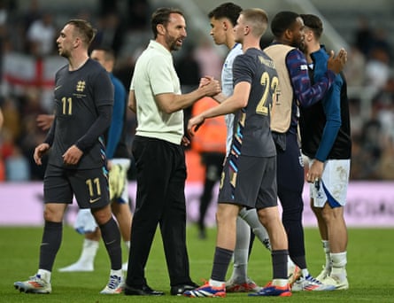 England’s manager Gareth Southgate congratulates midfielder Adam Wharton after this debut.