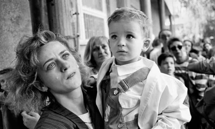 A mother prepares to send her child out of Sarajevo on a bus promised safe passage by the Serb forces during the siege in 1992.