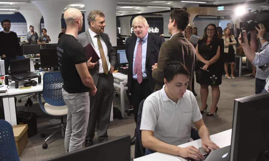 Boris Johnson (centre, second right) speaks with PayDock CEO Robert Lincolne (centre, left), British consul-general Michael Ward (centre, second left) and Head of Tyro Fintech Hub Andrew Corbett-Jones (centre, right), during a visit to the Tyro Fintech technology Hub in Sydney.