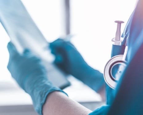 Doctor writing on a clipboard