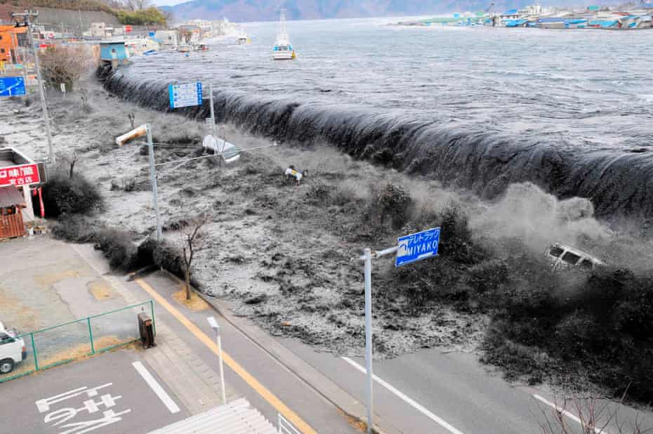 The wave from a tsunami crashes over a street in Miyako, in the Iwate prefecture of north-eastern Japan after the magnitude 8.9 earthquake struck the area. 11 March, 2011.
