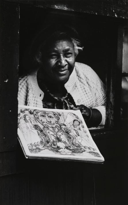 Minnie Evans in the Gatehouse of Airlie Gardens, Holding One of Her Crayon Drawings, 1970