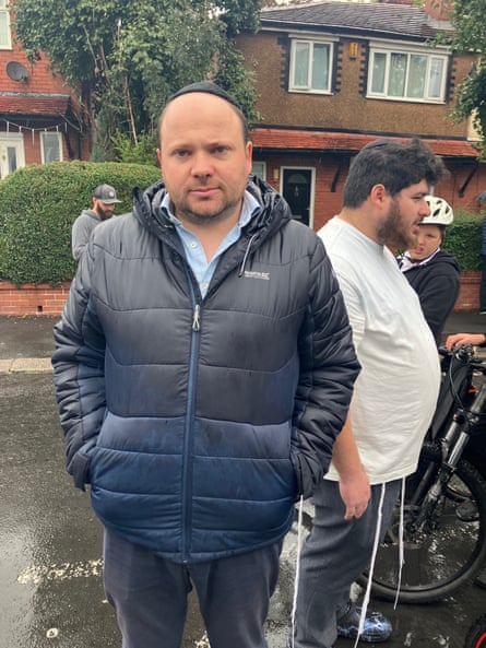 Man stands in street.