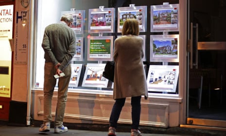 People view proporties in an estate agent's window