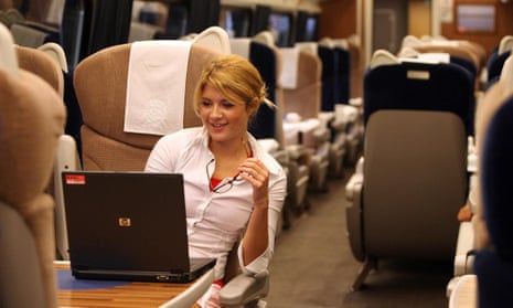 A woman uses a laptop on board a GNER train.