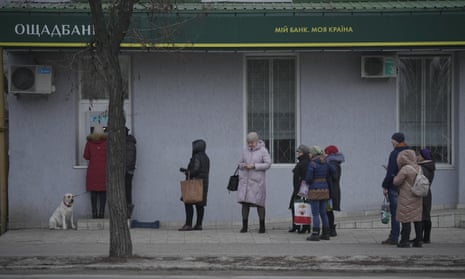 People queue to use a cash machine in Sievierodonetsk, Luhansk region, eastern Ukraine.