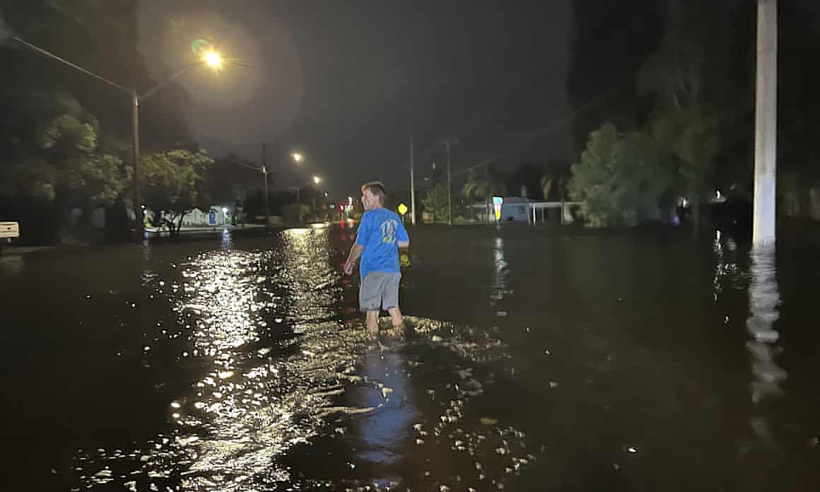 Man walks through the flood waters