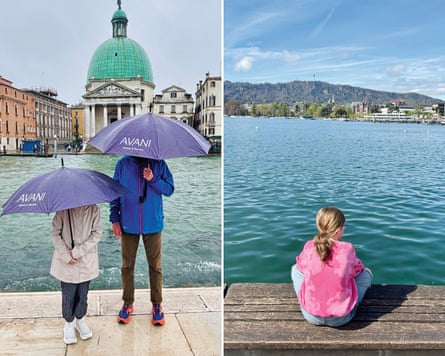A man and a young girl standing by a canal in Venice with umbrellas covering their heads, and a girl sitting on a jetty by a large lake