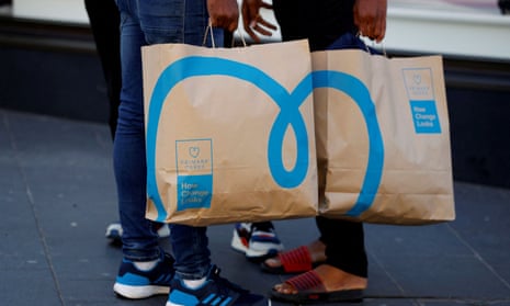 People hold Primark shopping bags