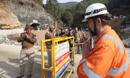 Arnold Dix (R), the President of the International Tunnelling and Underground Space Association, greets the people before entering the site of the tunnel collapse.