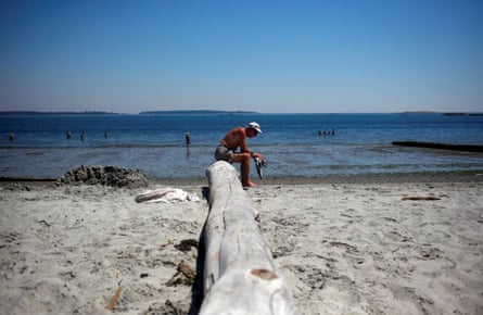 A man rests at Willow’s Beach, British Columbia, during the ‘heat dome’, in June.