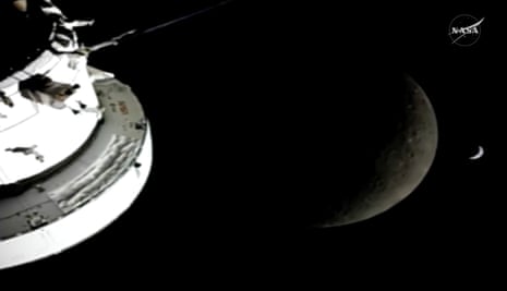 In this image from video provided by NASA, the Orion Spacecraft, the Earth and the Moon are seen from a camera as the Artemis II crew and spacecraft travel farther into space on Monday