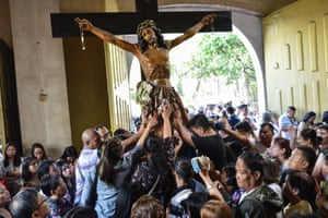 Catholic devotees in Manila surround a crucifix during a service on Ash Wednesday marking the start of Lent