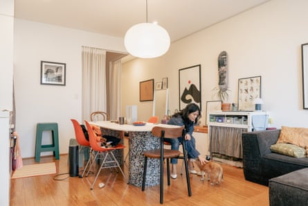 A woman and her dog in their open-plan apartment