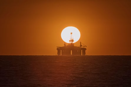 Sunset over an oil drilling rig on the ocean