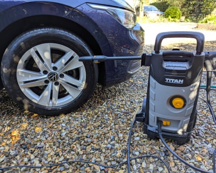 The Titan TTB1800PRW pressure washer sitting next to a car tyre it has just cleaned