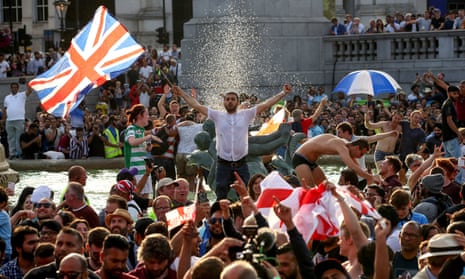 England fans celebrate in Trafalgar Square after watching England win the Cricket World Cup final