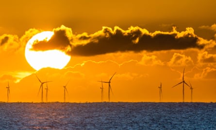 Sunrise over the Rampion offshore windfarm, off the coast of Sussex, England.