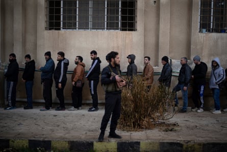 Members of ousted Syrian President Bashar Assad’s army line up to register with newly formed Syrian government as part of an ‘identification and reconciliation process’ in Homs, Syria, January 2025.