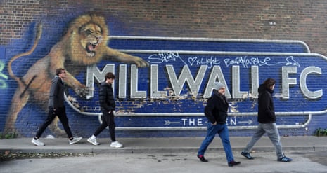 Millwall fans make their way past a mural featuring a pouncing lion en route to Den for this afternoon’s match between their side and Ipswich Town.